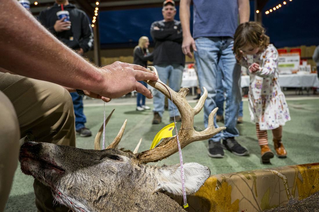 Green scoring a buck at the DeerFest check-in table